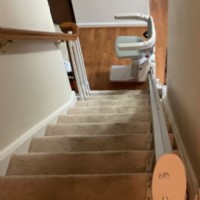 Bruno Elan stairlift at bottom of staircase in Baltimore home