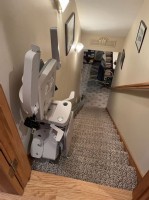 Bruno Elan stairlift with components folded up to maximize space on stairs in Indiana home