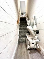Bruno curved stairlift with components folded up installed by Lifeway Mobility