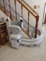 curved stairlift at bottom landing with seat folded up in Wichita KS by Lifeway Mobility