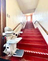 custom curved stairlift installed on red staircase in Columbus Ohio by Lifeway Mobility