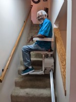 senior man riding stairlift installed by Lifeway Mobility Wichita