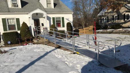 aluminum wheelchair ramp installed with snow on ground in MA