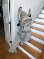 Bruno curved rail stairlift in Andover Massachusetts with seat and armrests folded up