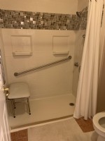 accesible shower in Indianapolis area home with diagonal grab bar and shower bench