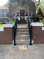 aluminum dual handrail installation on outdoor concrete stairs
