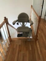 curved stairlift in Massachuetts at top landing with seat swiveled away from the stairs