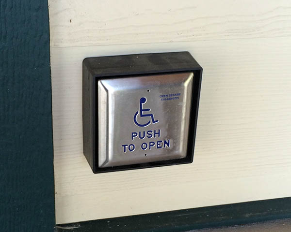 A wall switch to a handicap door opener