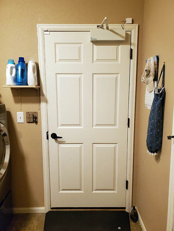 Automatic door opener for a home installed in a laundry room from the garage