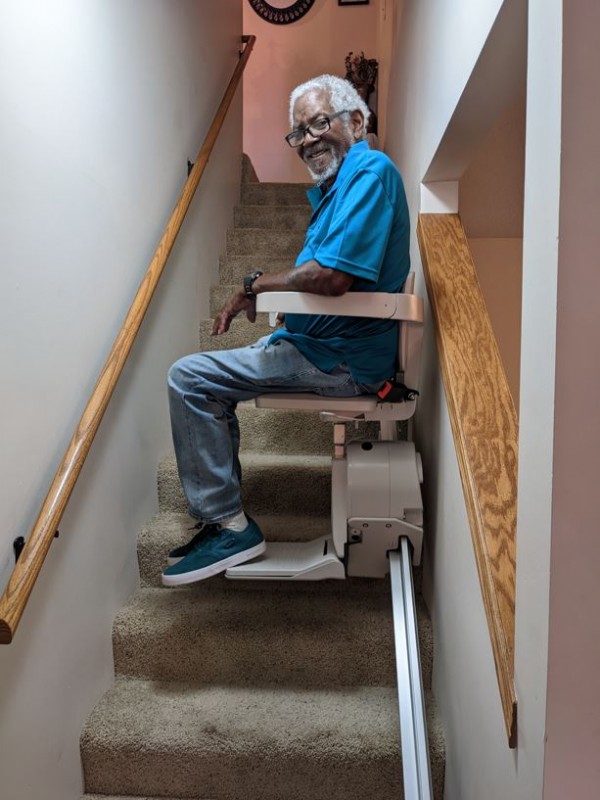senior man riding stairlift installed by Lifeway Mobility Wichita
