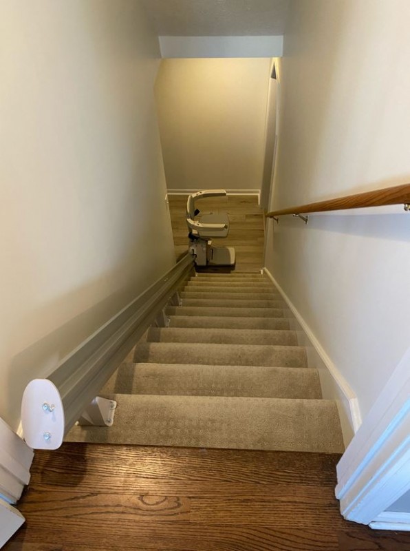 stairlift at bottom landing of stairs in home in Carmel Indiana installed by Lifeway Mobility