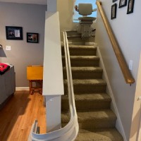 Bruno curved stairlift with chair at middle of staircase bottom view Lifeway Mobility Baltimore