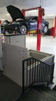 Commercial VPLs/commercial wheelchair lift in Tesla Motors service center with Tesla vehicle in background