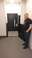 Goose Island employee standing next to commercial wheelchair lift built in hositway by Lifeway Mobility Chicago