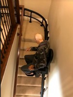 Lifeway Mobility Minnesota customer riding his new Harmar Helix curved stairlift